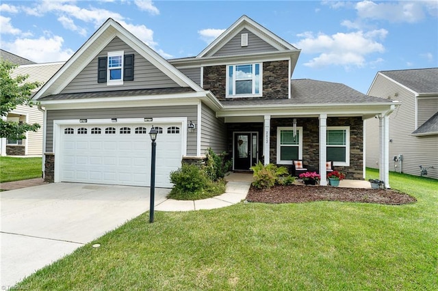 2452 Tannin Ct, High Point, NC 27265 - craftsman house with stone siding, covered porch, driveway, a front yard, and a garage