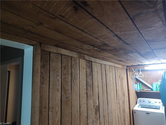 interior details featuring washer / dryer, wood ceiling, and wooden walls