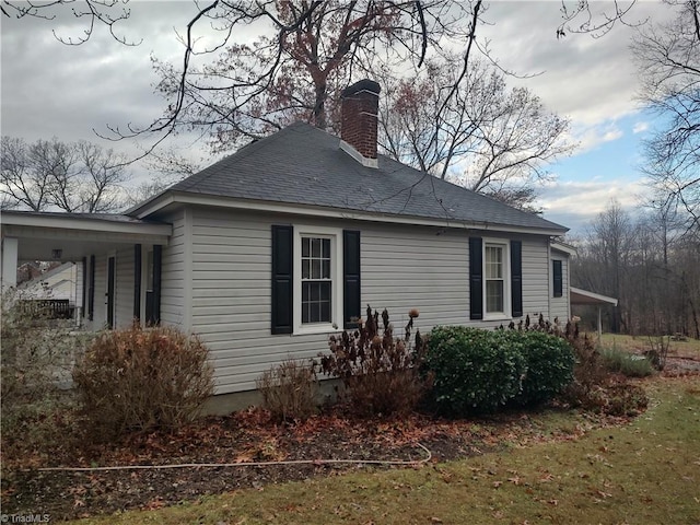 view of side of property with a yard