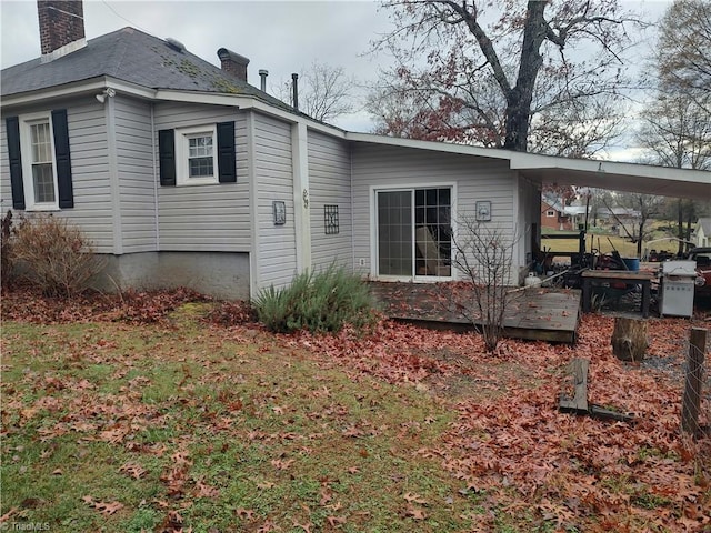 view of side of property with a carport