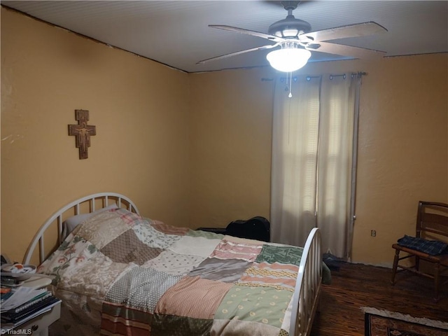 bedroom with dark hardwood / wood-style floors and ceiling fan