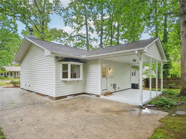 rear view of house with a patio, central air condition unit, and fence
