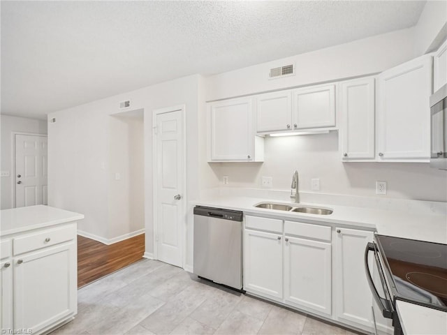 kitchen with stainless steel dishwasher, a sink, white cabinets, light countertops, and black range with electric cooktop