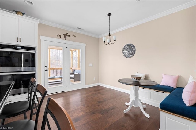 dining area with a chandelier, crown molding, breakfast area, and dark hardwood / wood-style flooring