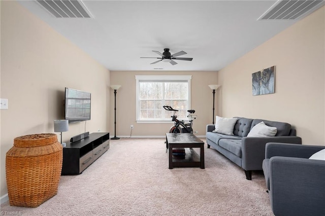 carpeted living room with ceiling fan