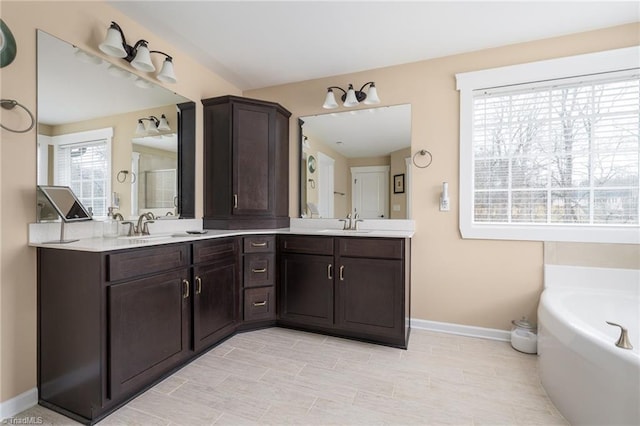 bathroom with vanity and a tub to relax in