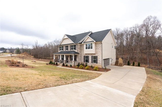 view of front facade featuring a garage, a front yard, and a porch