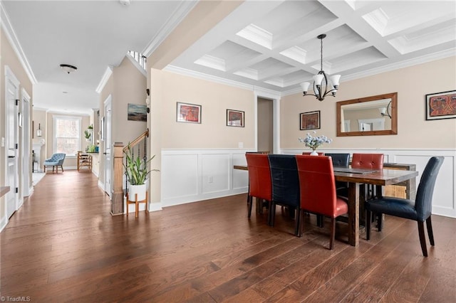 dining area featuring a chandelier, dark wood-type flooring, and beam ceiling