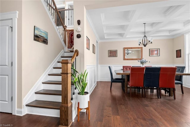 dining area with beam ceiling, a notable chandelier, coffered ceiling, dark hardwood / wood-style flooring, and ornamental molding