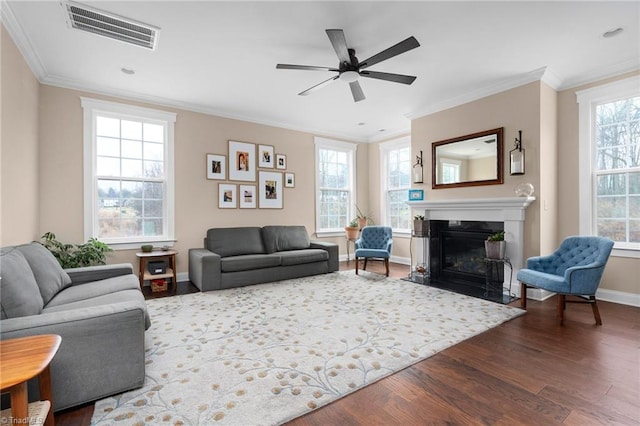 living room featuring ceiling fan, ornamental molding, and dark hardwood / wood-style floors