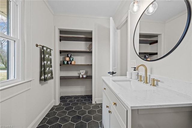 bathroom with a healthy amount of sunlight, vanity, and ornamental molding