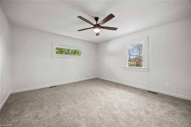 empty room featuring visible vents, baseboards, carpet, and ceiling fan