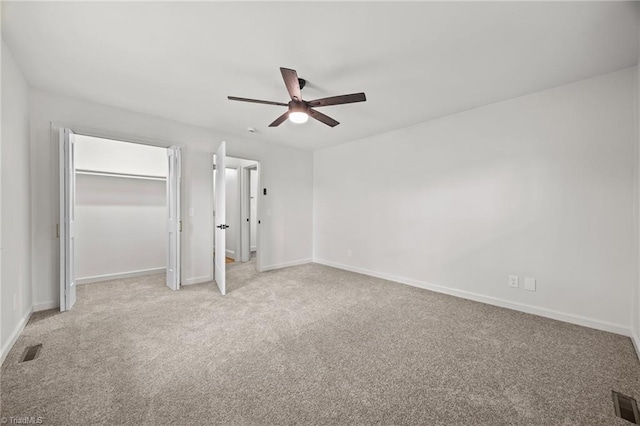 unfurnished bedroom featuring baseboards, visible vents, and light carpet