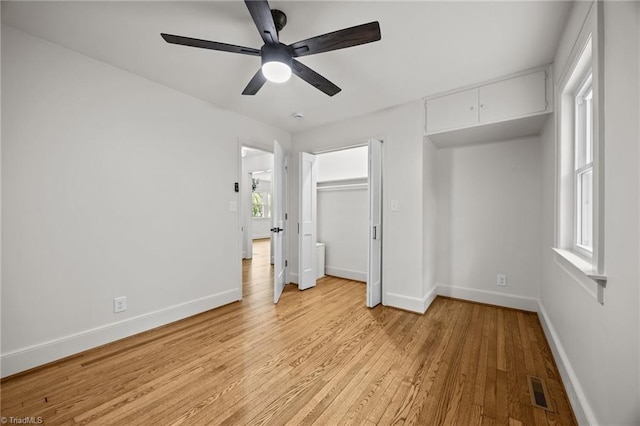 unfurnished bedroom featuring light wood finished floors, visible vents, ceiling fan, and baseboards