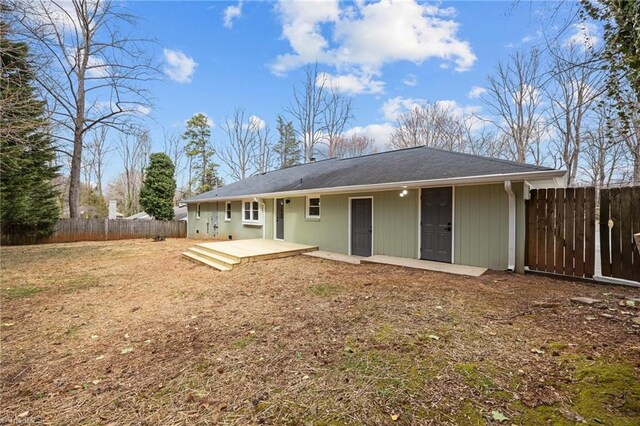 rear view of house featuring fence