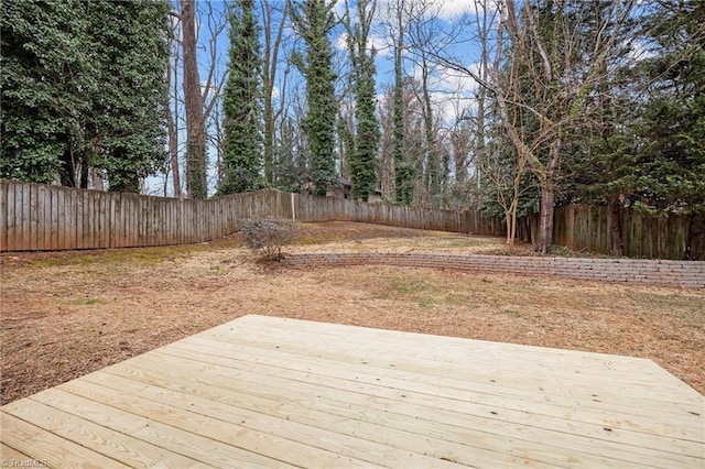 wooden terrace featuring a fenced backyard