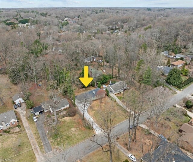 aerial view featuring a wooded view