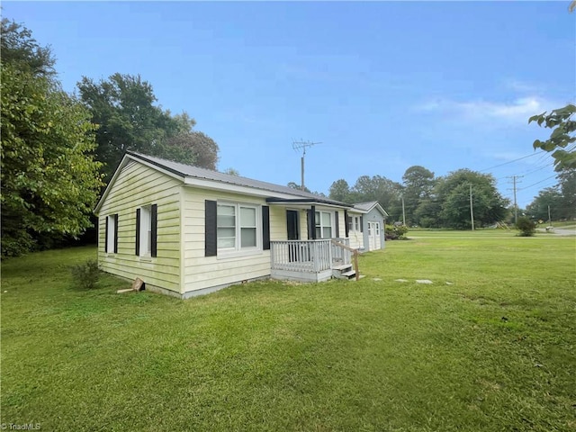 view of property exterior featuring covered porch and a yard