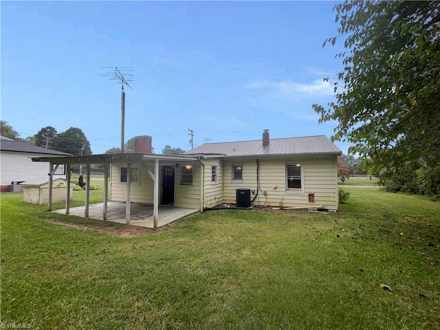 back of house featuring a yard, a patio, and central AC unit