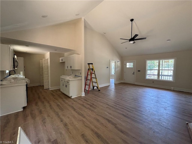 1017 Virginia St, Thomasville, NC 27360 - unfurnished living room featuring a ceiling fan, high vaulted ceiling, and dark wood finished floors