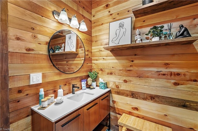 bathroom featuring vanity and wood walls