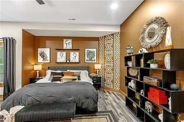 bedroom with hardwood / wood-style flooring and ceiling fan