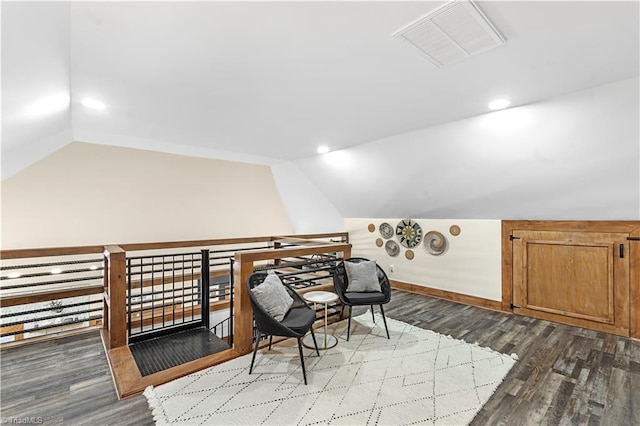 sitting room with wood-type flooring and vaulted ceiling