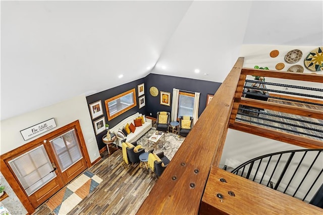 staircase featuring lofted ceiling and wood-type flooring