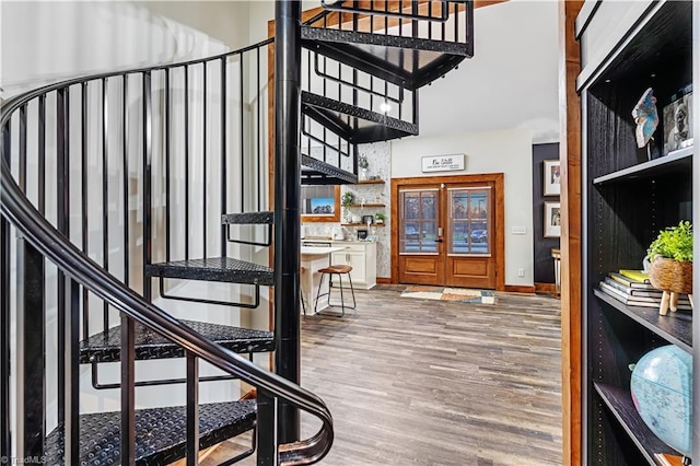 entryway with hardwood / wood-style floors and french doors