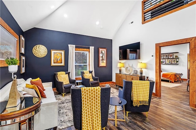 living room featuring wood-type flooring and high vaulted ceiling