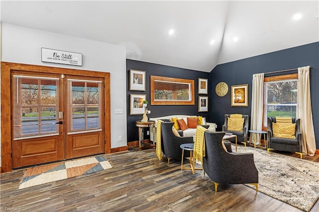 entrance foyer with lofted ceiling, hardwood / wood-style flooring, and french doors