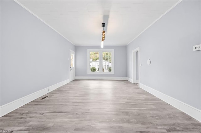 interior space with light hardwood / wood-style floors and ornamental molding