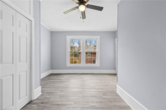 spare room featuring light wood-type flooring and ceiling fan