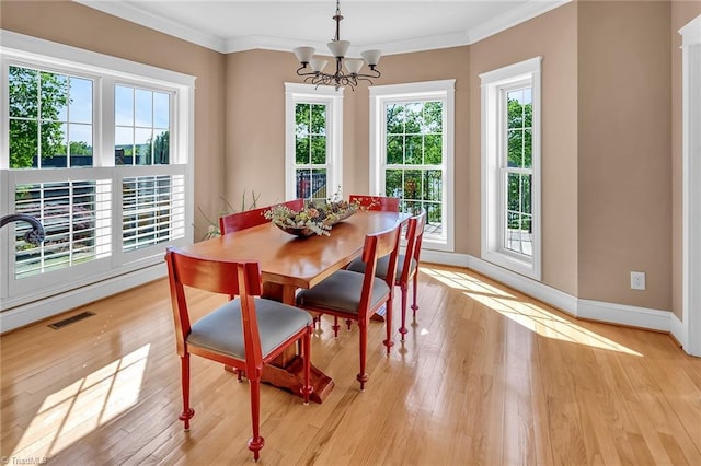 338 Fairfield Ct, Mount Gilead, NC 27306 - dining area featuring ornamental molding, baseboards, a chandelier, and light wood-style flooring