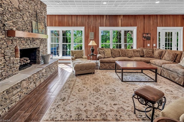 338 Fairfield Ct, Mount Gilead, NC 27306 - living room featuring healthy amount of natural light, dark wood-type flooring, a stone fireplace, wood walls, and recessed lighting
