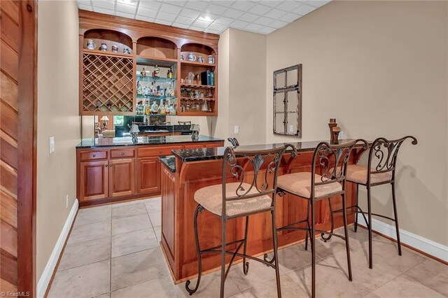 338 Fairfield Ct, Mount Gilead, NC 27306 - indoor wet bar with baseboards and light tile patterned flooring