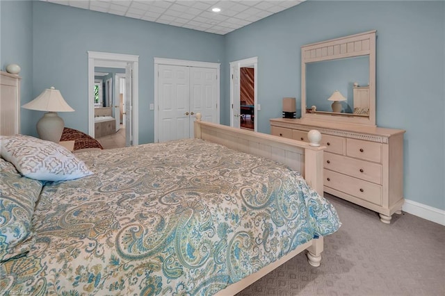 338 Fairfield Ct, Mount Gilead, NC 27306 - carpeted bedroom featuring a closet, baseboards, connected bathroom, a drop ceiling, and recessed lighting