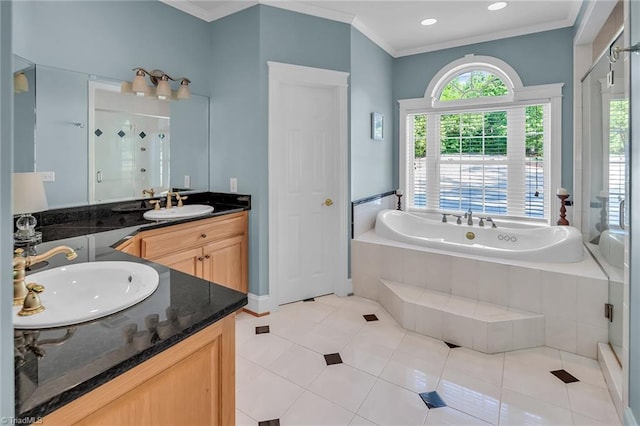 338 Fairfield Ct, Mount Gilead, NC 27306 - bathroom featuring two vanities, a stall shower, a bath, crown molding, and tile patterned floors