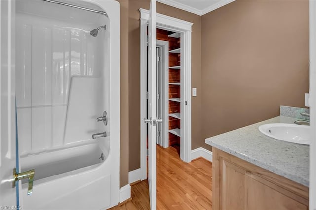 338 Fairfield Ct, Mount Gilead, NC 27306 - full bathroom featuring vanity, shower / bathtub combination, wood finished floors, baseboards, and ornamental molding