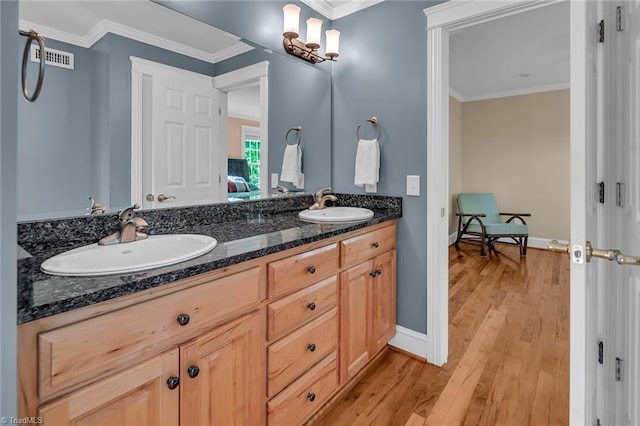 338 Fairfield Ct, Mount Gilead, NC 27306 - bathroom featuring double vanity, crown molding, wood finished floors, and baseboards