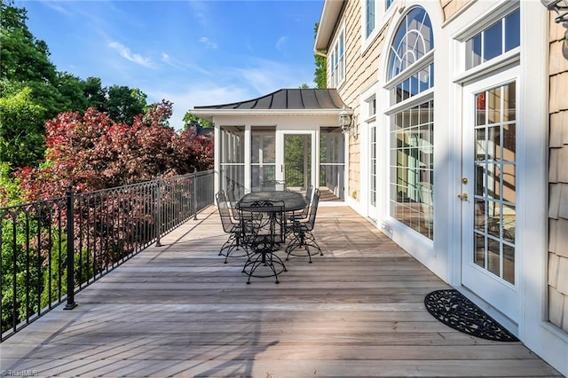 338 Fairfield Ct, Mount Gilead, NC 27306 - wooden deck featuring a sunroom and outdoor dining area