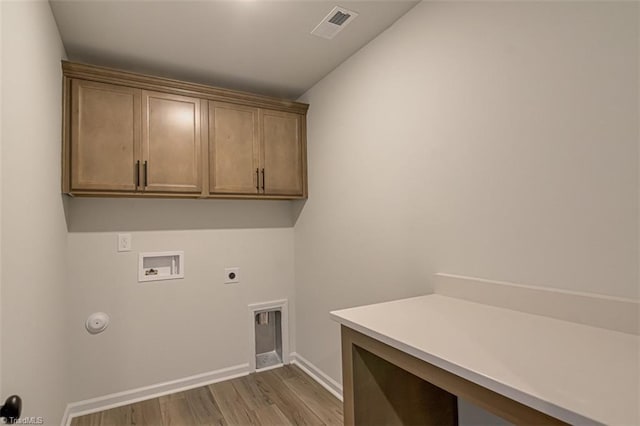 laundry room with cabinet space, visible vents, dark wood finished floors, hookup for a washing machine, and electric dryer hookup