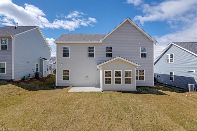 back of property with central air condition unit, a patio area, and a yard