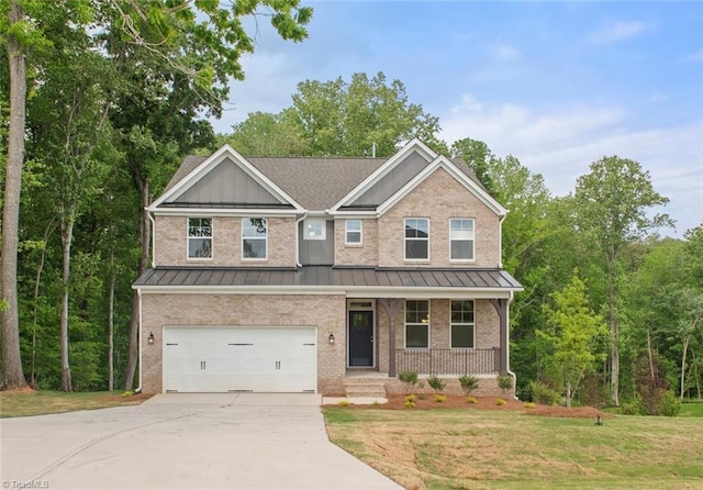 craftsman-style house with a garage, a front lawn, and covered porch