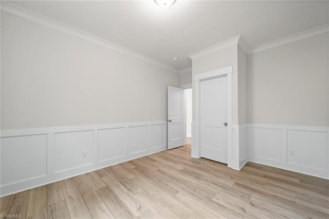 unfurnished room with light hardwood / wood-style flooring and ornamental molding