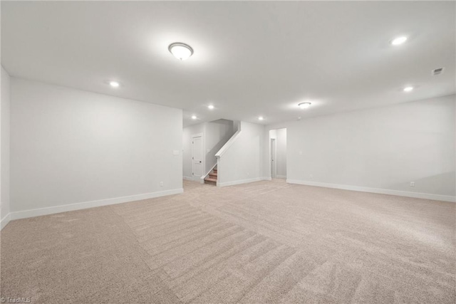 basement featuring light carpet