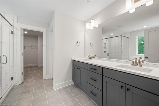 bathroom featuring vanity, tile patterned flooring, and a shower with door