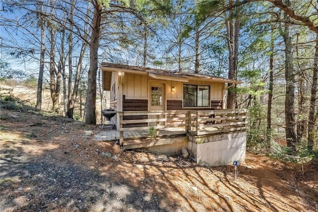 chalet / cabin featuring board and batten siding and a deck