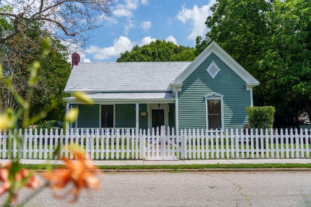 301 S Shaver St, Salisbury, NC 28144 - view of front of home featuring covered porch, a chimney, and a fenced front yard