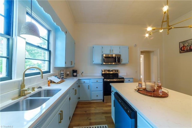 301 S Shaver St, Salisbury, NC 28144 - kitchen with appliances with stainless steel finishes, a chandelier, dark wood finished floors, light countertops, and ornamental molding